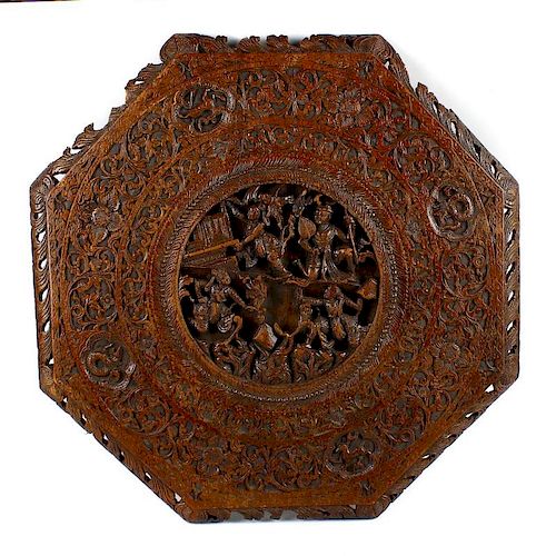 A 19th century Chinese carved wooden octagonal table top. The centre modelled in deep relief with fo