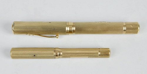 Two Watermans Ideal 9ct gold fountain pens, each having an engine turned cylindrical barrel with ful