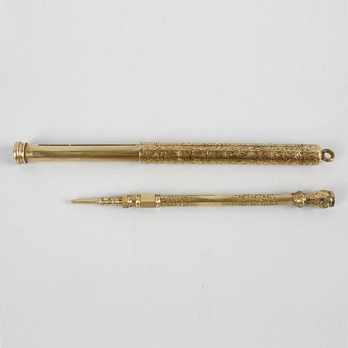 Two yellow metal retractable pencils. The first of cylindrical form having scrolling foliate decorat
