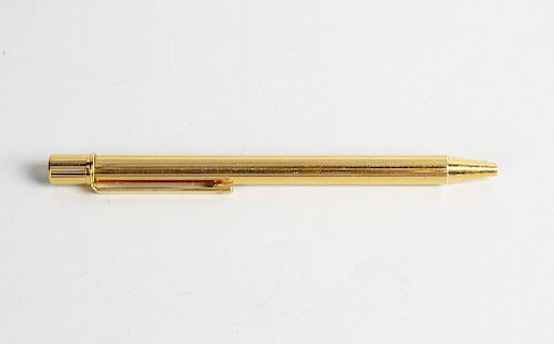 A gold plated Must de Cartier ballpoint pen. The ribbed body with plain clip having Cartier emblem,