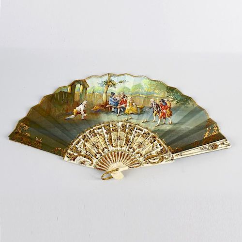 An early 20th century painted silk fan. Decorated with figures playing bowls before onlookers in a g