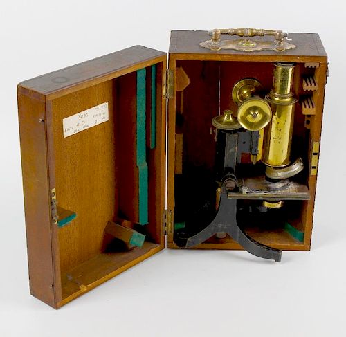 A students brass microscope. 8 (20.25) high fully extended, in hinged wooden box. <br><br>Displaying