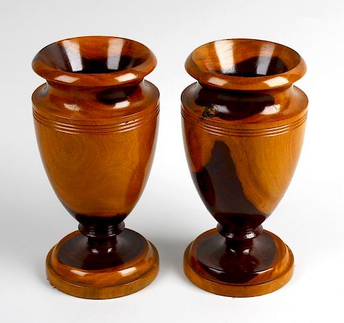A pair of treen vases Each of neoclassical urn form, in turned laburnum, 7.5, (19cm) high, together