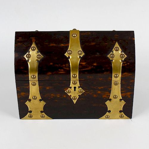 A coromandel stationary box. Having plain brass strap work to the exterior, the lancet arched hinged