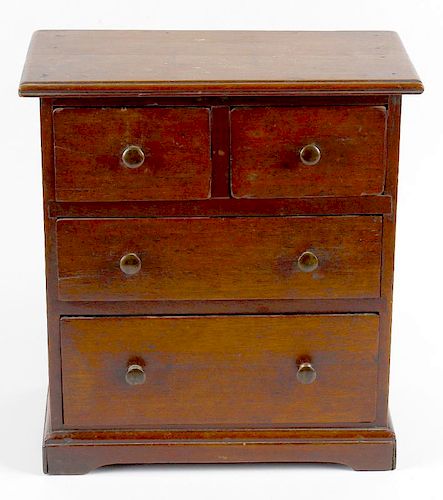 A 19th century mahogany miniature chest of drawers. Perhaps an apprentice piece, the rectangular top