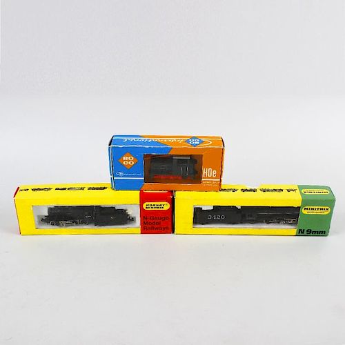 A box containing two Hornby Minitrix N gauge model railway locomotives, an unboxed N gauge model rai