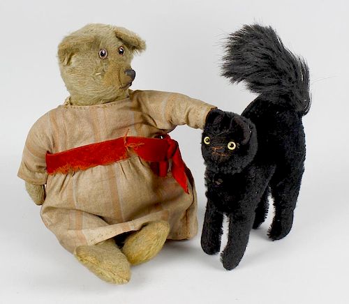 A small group of toys. Comprising a straw-filled plush teddy bear with glass eyes, arm pads and seam