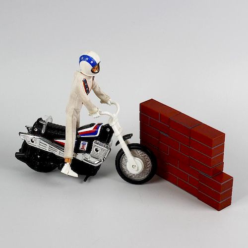 A box containing an Ideal Evel Knievel scramble van in original box, other Evel Knievel items, a mix