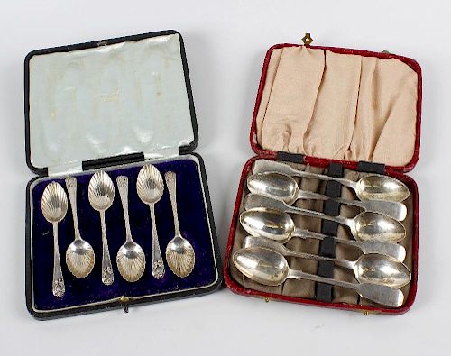 A box containing a cased set of six hallmarked silver teaspoons, each with shell shaped bowl, London