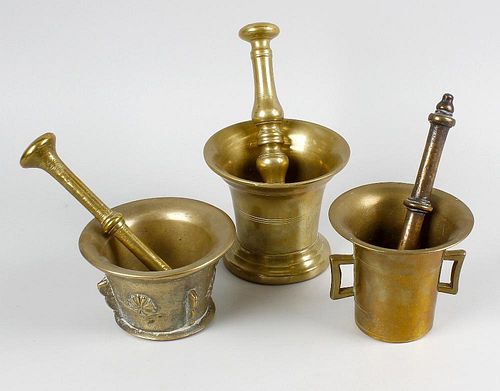 A box containing seven assorted bell metal mortars with pestles. Each of typical flared bucket form,