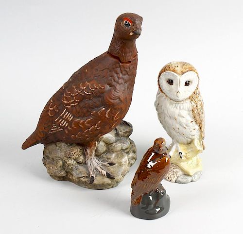 A box containing a selection of novelty whisky decanters. Each modelled as various birds to include