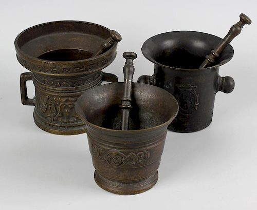 A box containing seven assorted cast mortars with pestles. The largest in 15th century style with ps