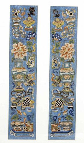 A pair of Chinese silk panels, of near symmetrical design, embroidered with vases of flowers, incens