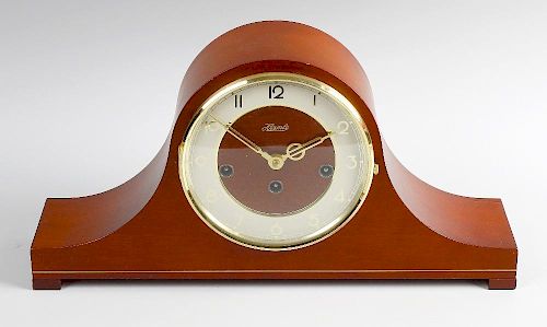 A modern Hermle 'Napoleon's hat' chiming mantel clock. The cream Arabic chapter ring, within mahogan