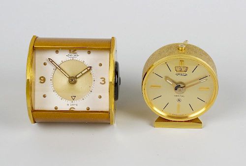 Two Jaeger travel clocks. The first with rectangular dial having gilt circular chapter with Arabic q