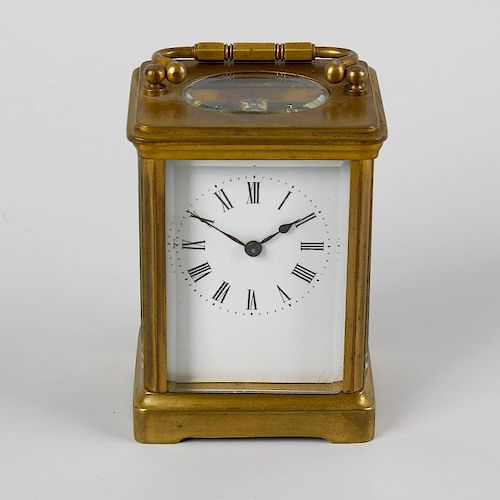 A late 19th century brass cased carriage clock. The 2 inch white dial with black Roman numerals and