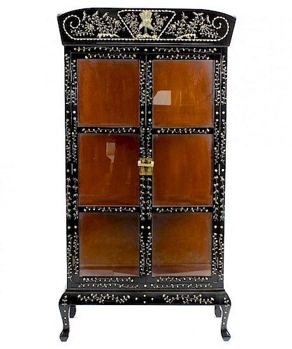 An Oriental black lacquered and mother-of-pearl inlaid display cabinet. Having foliate and peacock i