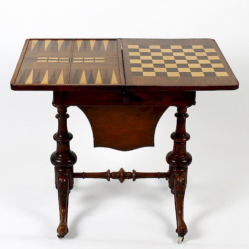 A mid Victorian inlaid walnut fold over games/work table. the figured quarter veneered top with cent
