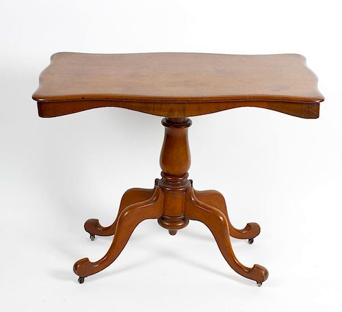 A Victorian mahogany pedestal centre table. The serpentine-sided oblong top on a bulbous stem and fo