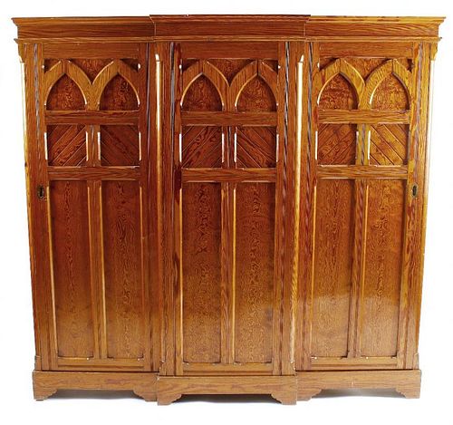A Victorian gothic revival pitch pine hall wardrobe Of breakfront form with moulded cornice over thr