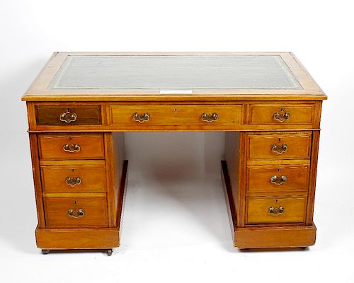 A late Victorian walnut pedestal desk with dated provenance The later gilt-tooled green skiver with