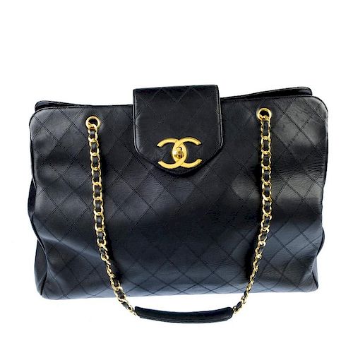 CHANEL - a Jumbo Super Model Tote. Featuring a quilted black leather exterior, polished gold-tone ha