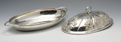 A George III silver entree dish and cover, the oval form with reeded rim and twin handles and later