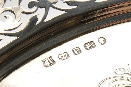 A mid-Victorian silver salver of shaped circular form with foliate scroll pierced rim enclosing a si