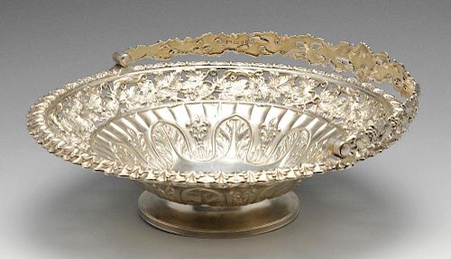 A George IV silver swing handle basket, the circular form fluted and rising to an openwork vine gall
