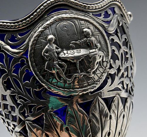 A George III silver sugar basket, the pierced form embellished with classical medallions amidst swag