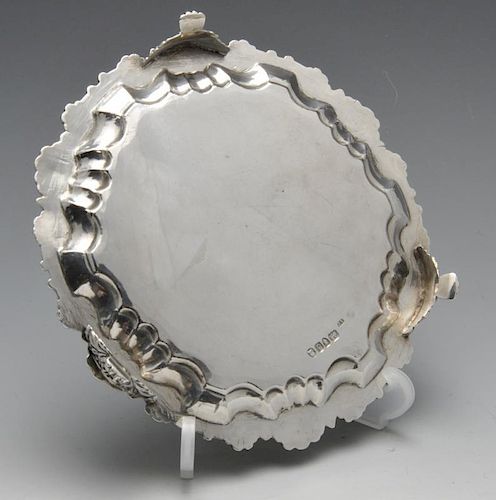 A late George III small silver salver, the circular form with shaped shell and scroll rim to a plain