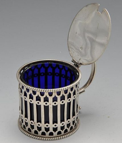 A Victorian silver drum mustard pot of pierced openwork form and blue glass liner. Hallmarked Elking