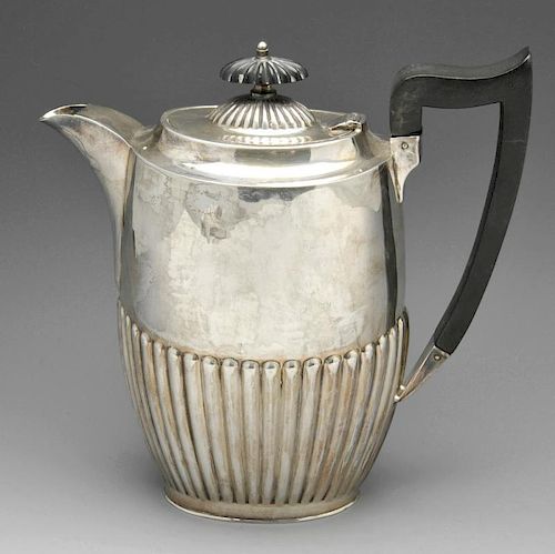 A 1920's silver teapot, of oval outline and part reeded form with applied ebonised handle and finial