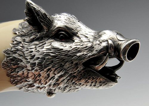 An Austrian silver mounted boar tusk cigar cutter, circa 1900, the realistically modelled boars head
