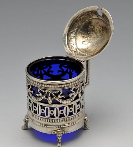 A German silver mustard pot with blue glass liner, having ribbon and garland swag piercing above geo