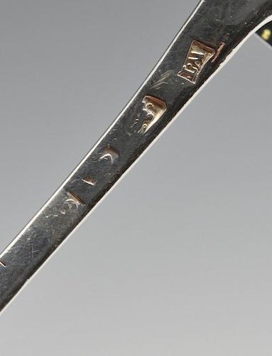 An early George III silver toddy ladle with feather edge and vacant scrolled cartouche to terminal.