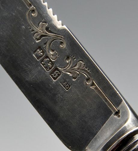 A George V silver bread knife, the blade having scrolling border to the serrated edge leading to the
