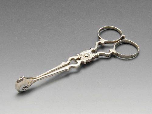 A pair of George III silver scissor action sugar tongs with scrolling body. Lion passant only visibl