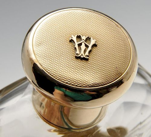 A 1920's 9ct gold mounted hip flask, the glass body with faceted shoulders, detachable cup and monog