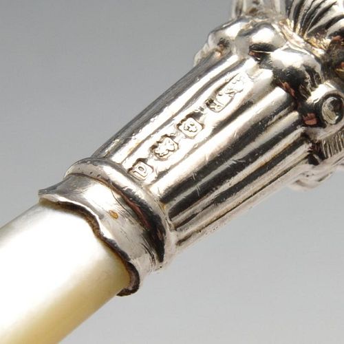 An Edwardian silver mounted rattle, of baluster form with whistle, bell suspensions and mother-of-pe