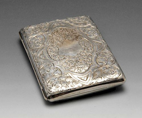 A late Victorian silver aide memoire, finely decorated with engraved foliate scrollwork to the whole