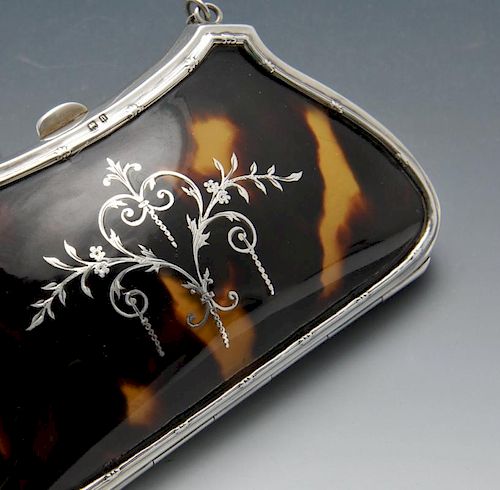 An early twentieth century silver and tortoiseshell purse, the shaped and tapered body further inlai