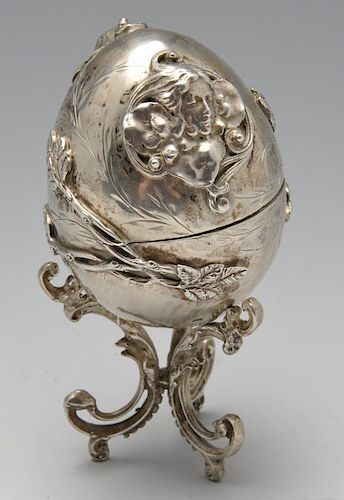 A late nineteenth century Eastern European egg ornament on stand, applied decoration of twin opposed
