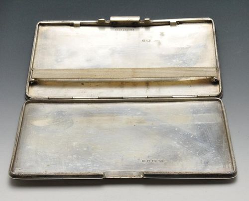 An early twentieth century silver cigarette case of oblong form and engine-turned decoration with go