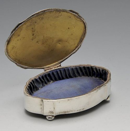A 1920's silver mounted trinket box, of plain oval outline having lined interior and gilding to inne