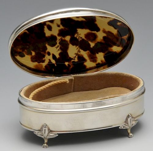 An early twentieth century silver and tortoiseshell trinket box, the oval form inlaid with a floral
