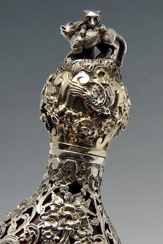A French scent bottle, the cranberry glass body of tapered form and overlaid with scroll open-work s