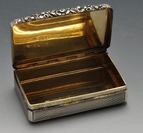 A George IV silver snuff box, the oblong form with engine-turned decoration, crested circular cartou