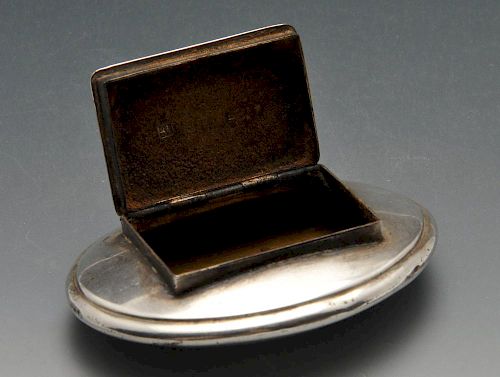 A George III silver snuff box of oval form with oblong hinged opening and applied vacant cartouche.