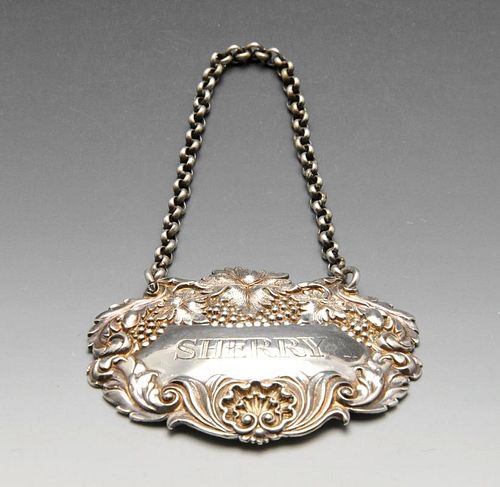 An early Victorian silver Sherry label with fruiting vine surround and suspended on belcher link cha